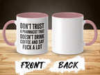 White mug with pink handle, text reads "Don't trust a pharmacist that doesn't drink coffee and say fuck a lot."