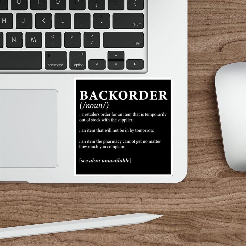 Black sticker with "BACKORDER" definition, on a laptop keyboard.
