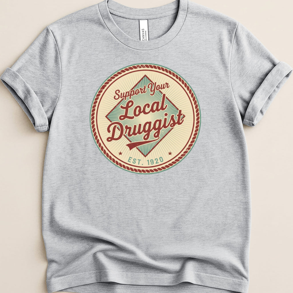 T-shirt with "Support Your Local Druggist EST. 1920" circular logo.