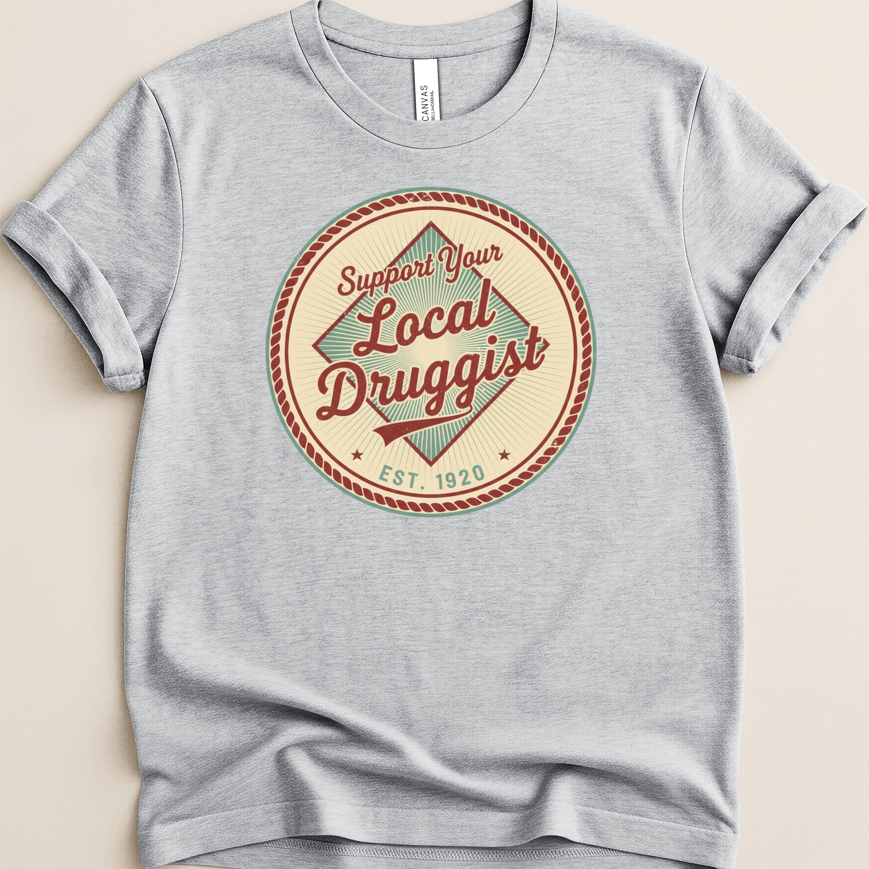 T-shirt with "Support Your Local Druggist EST. 1920" circular logo.