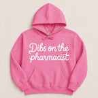 Pink hoodie with white text "Dibs on the pharmacist".