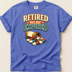 T-shirt with text "Retired But Not Expired" and spilled pill bottle.