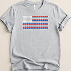 T-shirt with American flag design made of red, white, and blue pill capsules.