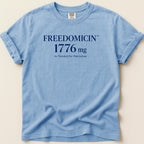 Light blue Comfort Colors t-shirt with "FREEDOMCIN 1776 mg As Needed for Patriotism" text.