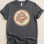 Dark t-shirt with circular "Support Your Local Druggist Est. 1920" graphic.