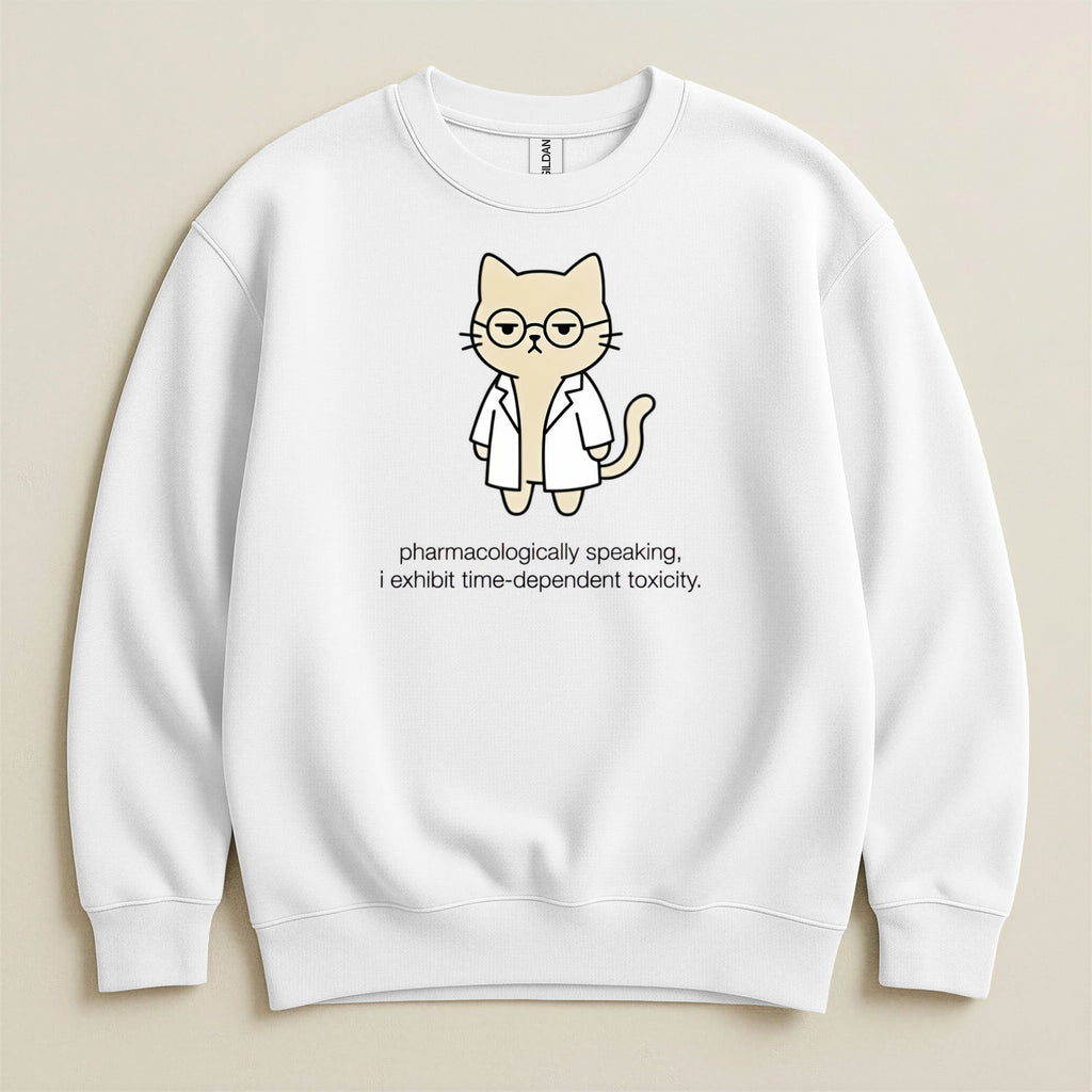 White sweatshirt with cartoon cat in lab coat and glasses, text reads "pharmacologically speaking, i exhibit time-dependent toxicity."