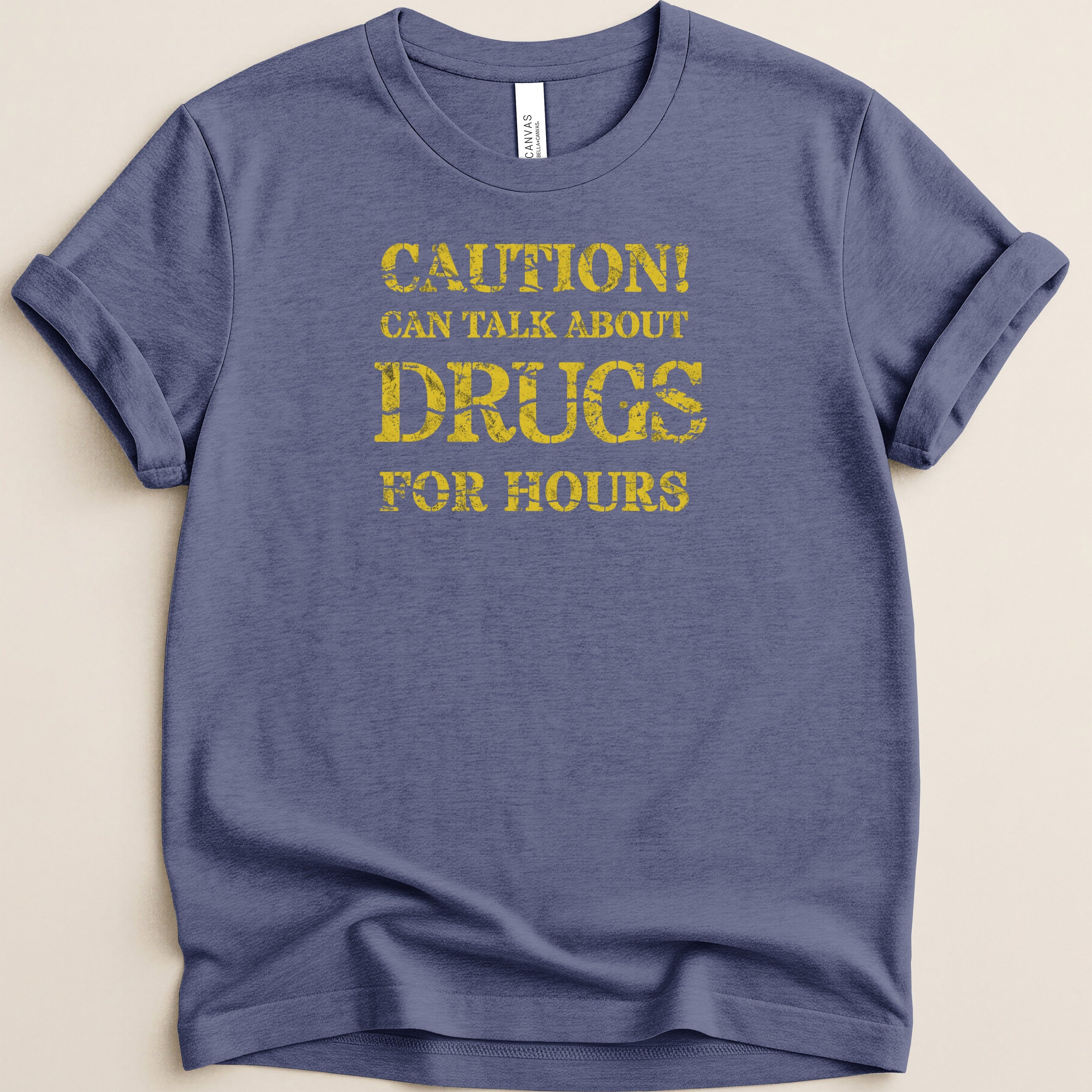 Blue t-shirt with yellow text "CAUTION! CAN TALK ABOUT DRUGS FOR HOURS"