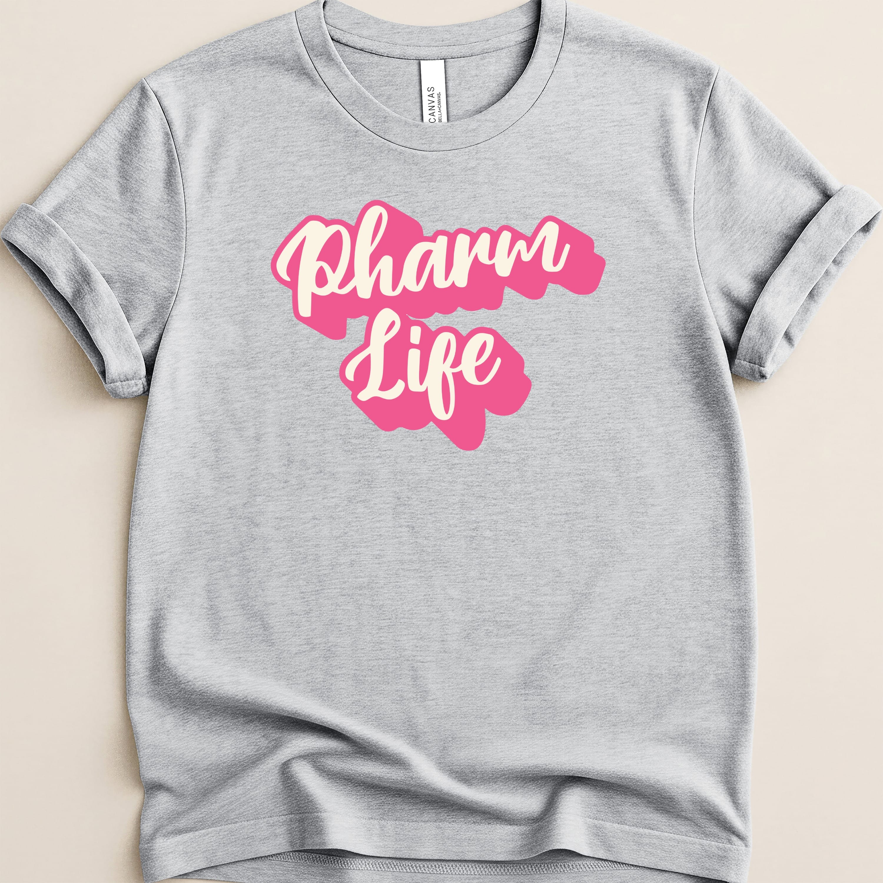 Grey t-shirt with "Pharm Life" text in pink script.