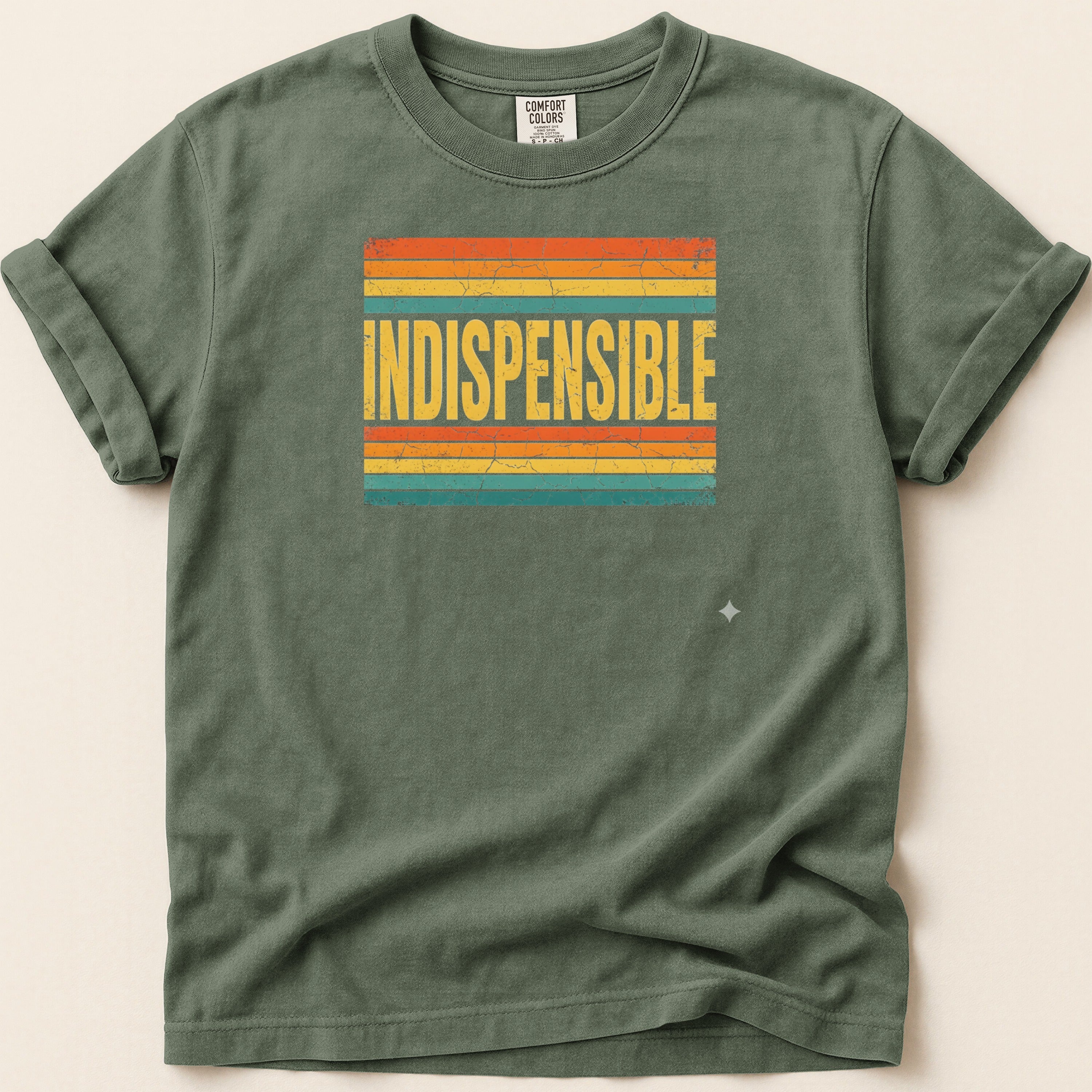 Green t-shirt with "INDISPENSABLE" text on a striped background.