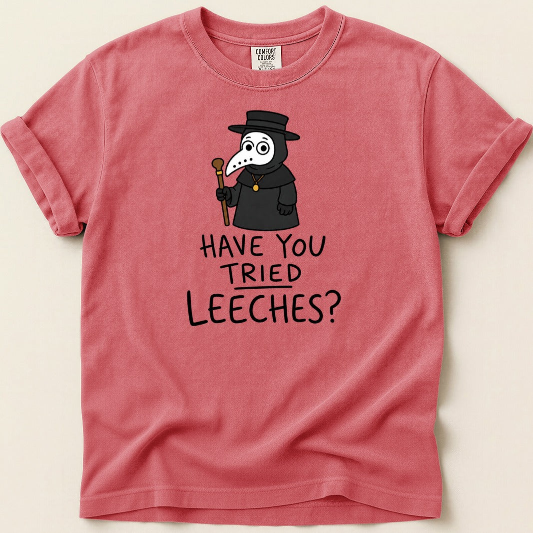 Salmon pink t-shirt with cartoon plague doctor and text "Have You Tried Leeches?".