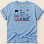 Blue t-shirt with vial graphic and text "Have you tried turning it off and on again?"