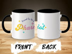 Mug with "Proud to be a Pharmacist" text and rainbow gradient on a wooden background.