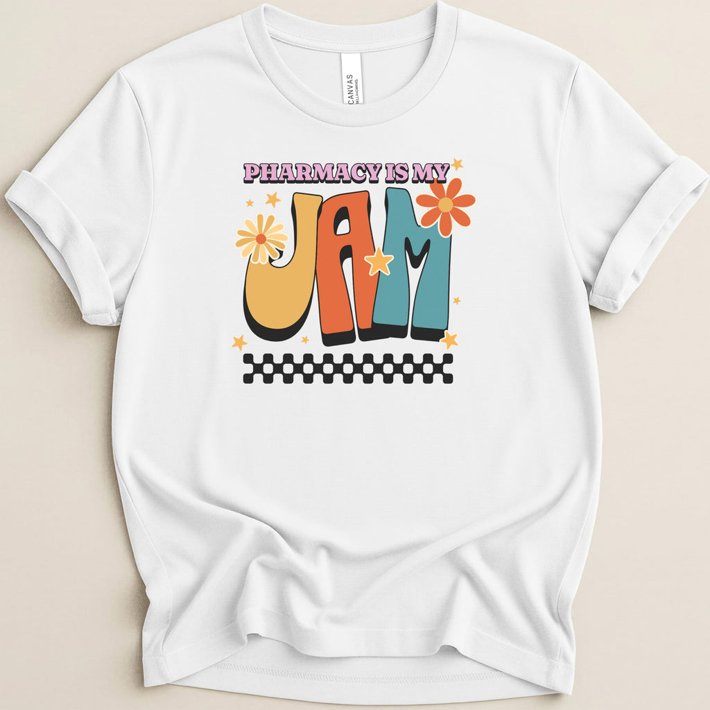White t-shirt with "PHARMACY IS MY JAM" in colorful retro lettering and floral accents.