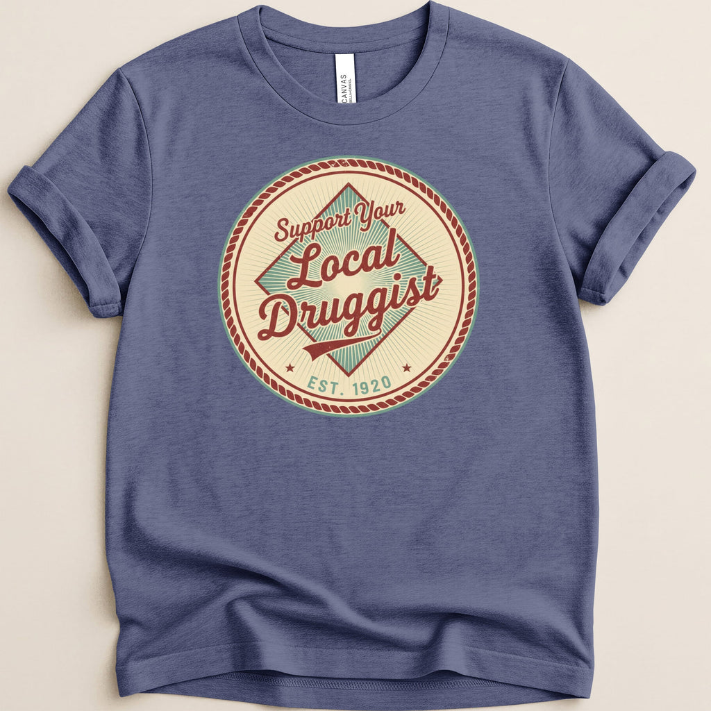 T-shirt with "Support Your Local Druggist Est. 1920" circular logo.
