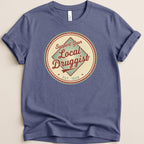 T-shirt with "Support Your Local Druggist Est. 1920" circular logo.