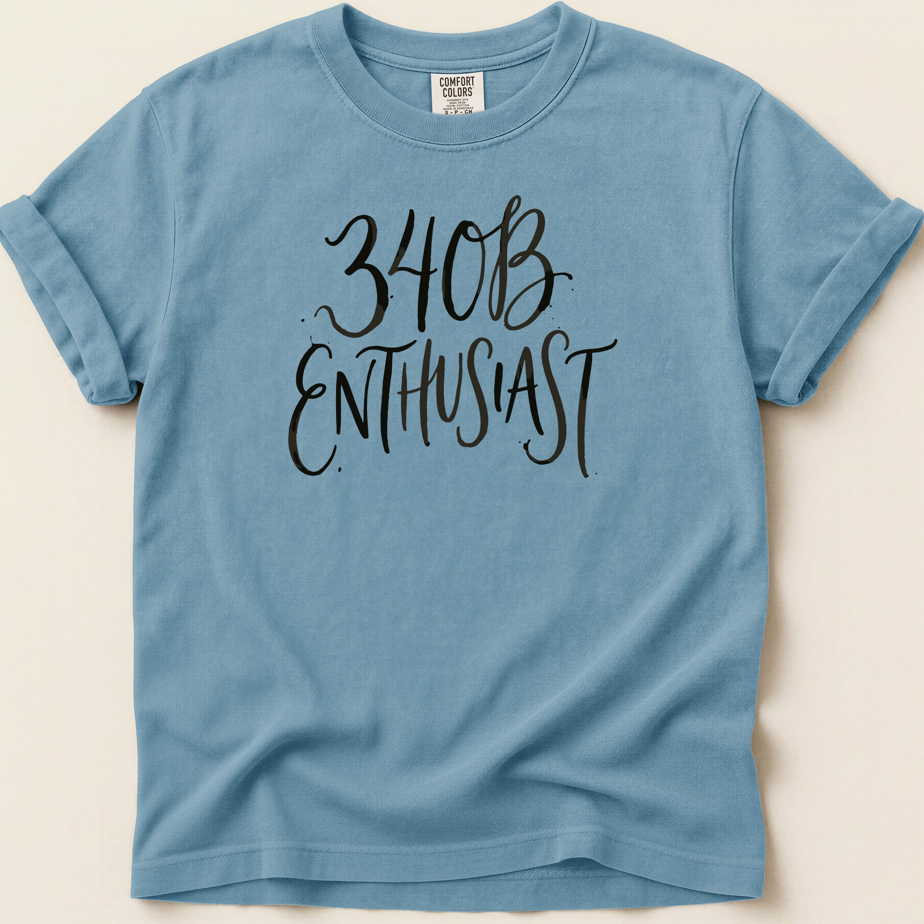 Blue t-shirt with black text "340B ENTHUSIAST" and Comfort Colors branding.