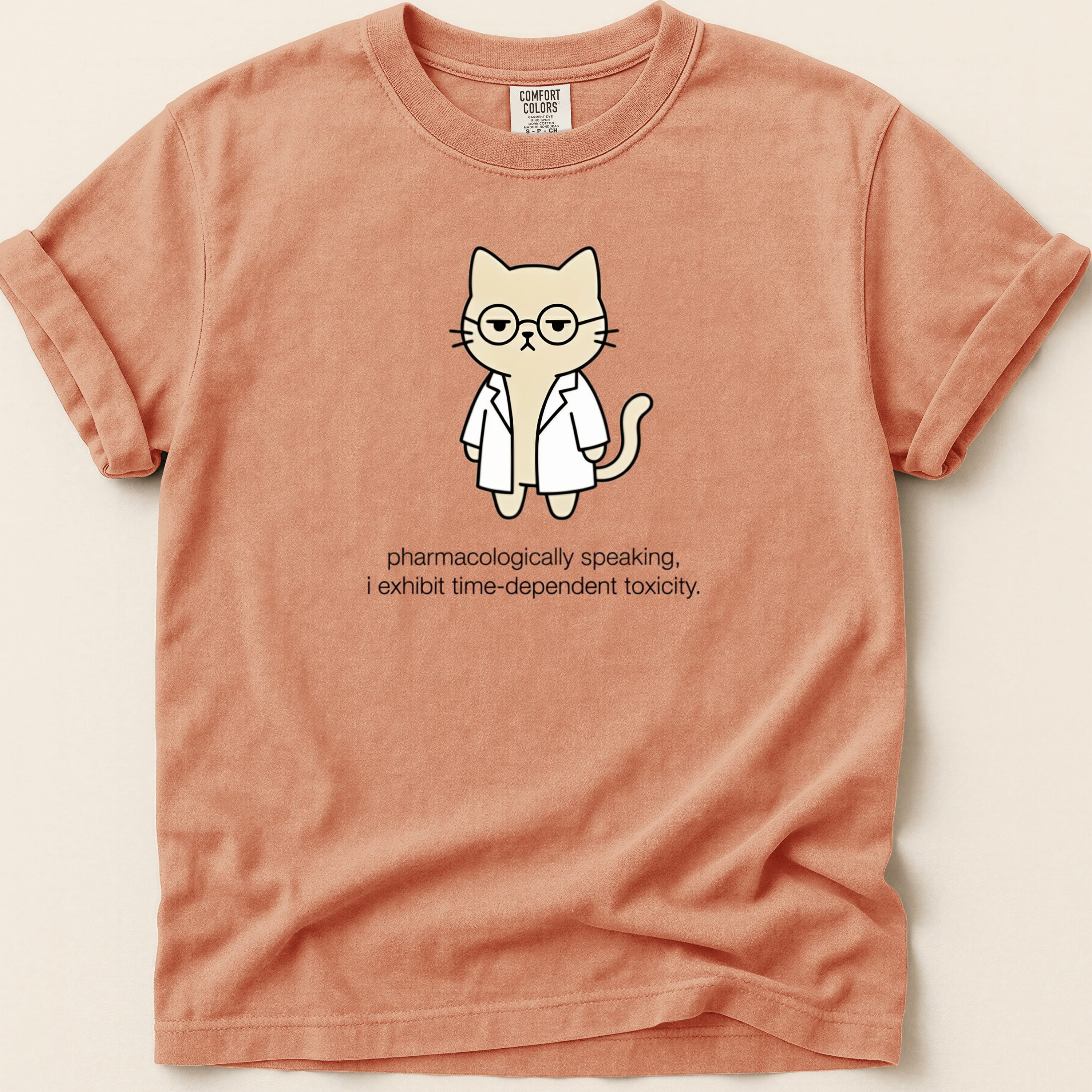 T-shirt with cartoon cat in lab coat, text "pharmacologically speaking, i exhibit time-dependent toxicity."
