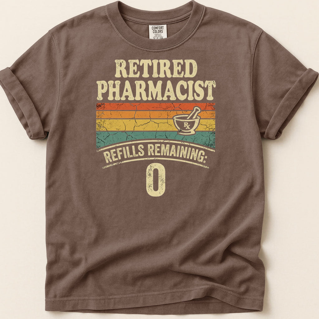 Retired Pharmacist text with refills remaining: 0, on a brown t-shirt.
