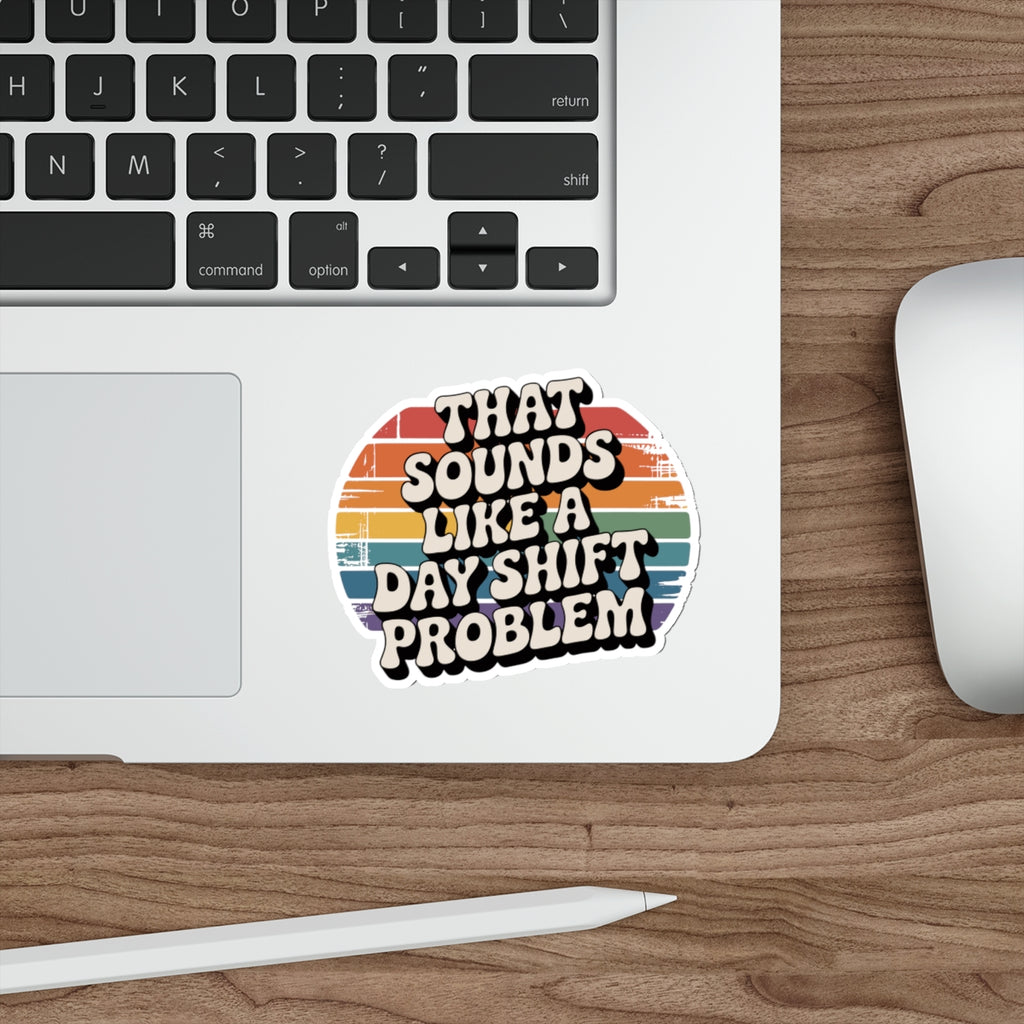 Sticker with rainbow stripes and text "THAT SOUNDS LIKE A DAY SHIFT PROBLEM".
