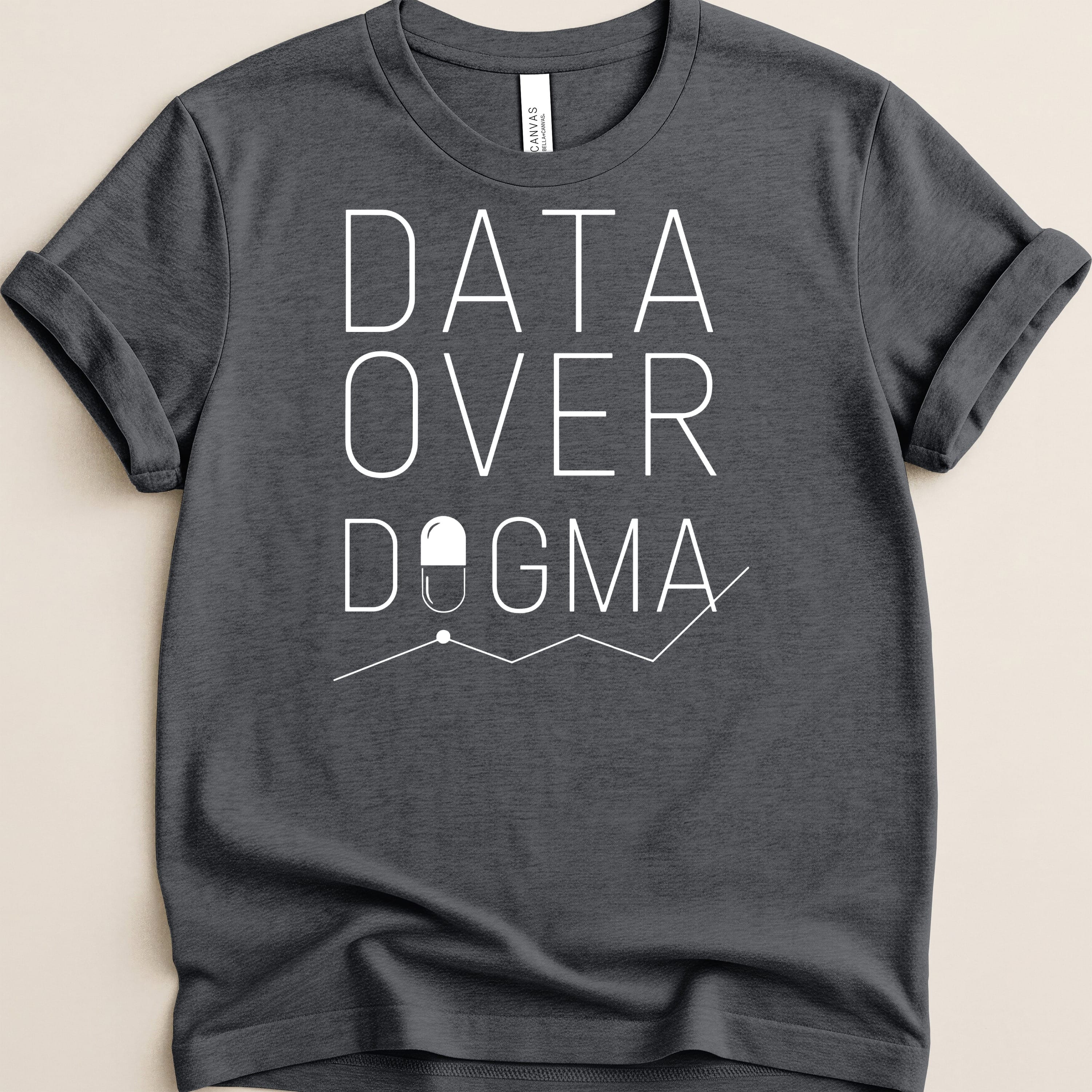 Dark t-shirt with "DATA OVER DOGMA" text and a pill icon.