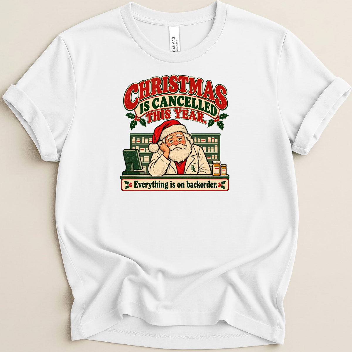 A white t-shirt featuring a vintage graphic of Santa Claus as a pharmacist with text reading Christmas is cancelled this year.