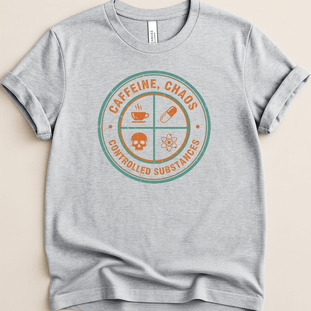Grey t-shirt with circular graphic reading "CAFFEINE, CHAOS CONTROLLED SUBSTANCES" and icons.
