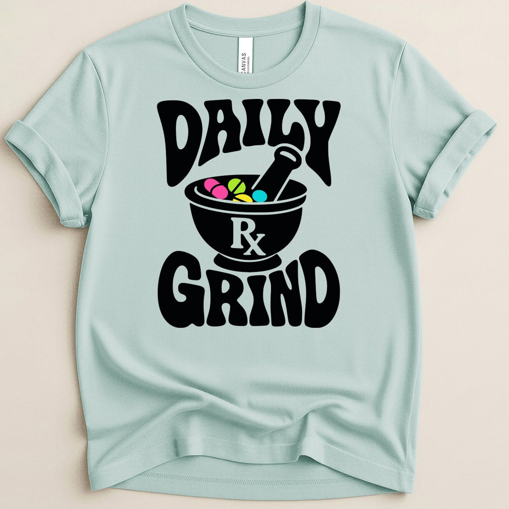 Light blue t-shirt with black text and graphics "DAILY GRIND" and a mortar and pestle with pills.