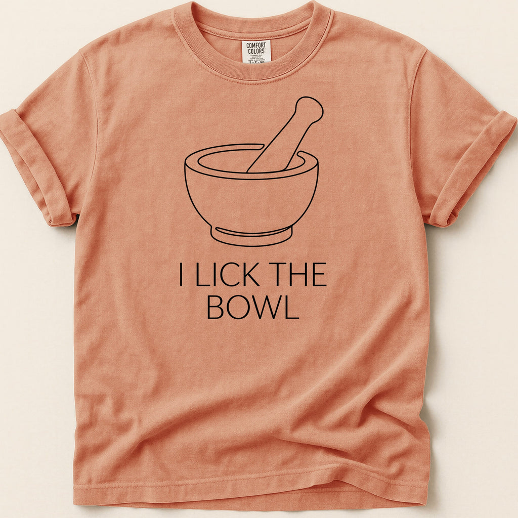 Peach t-shirt with "I LICK THE BOWL" and a mortar and pestle graphic.