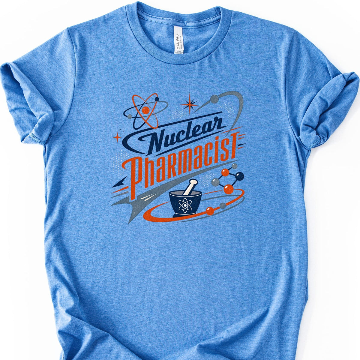 Blue t-shirt with "Nuclear Pharmacist" text and atomic graphics.