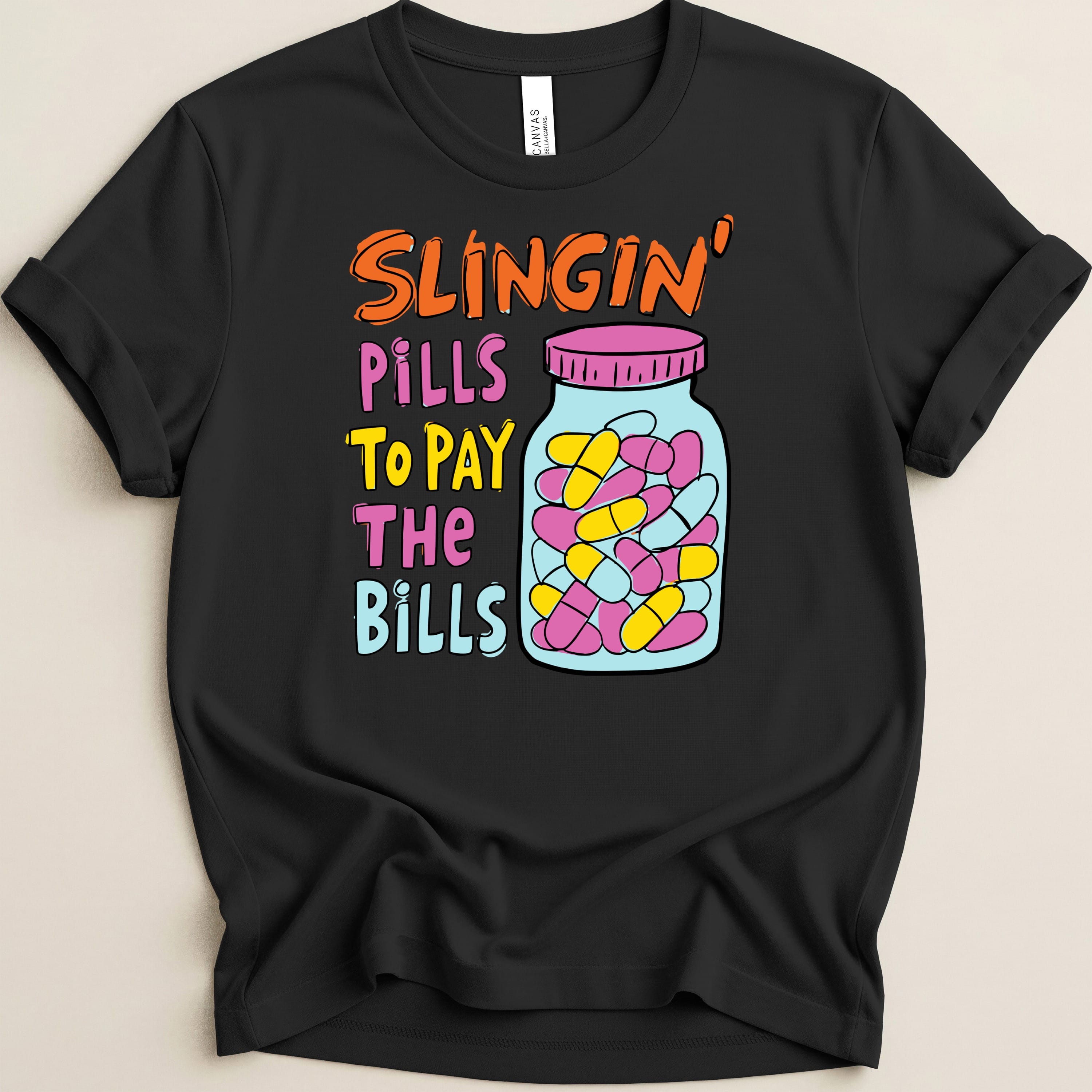 Black t-shirt with "Slingin' Pills To Pay The Bills" text and pill bottle graphic.
