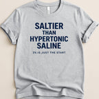 Gray t-shirt with "SALTIER THAN HYPERTONIC SALINE 3% IS JUST THE START" text.