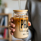 Glass tumbler with "PHA st ALL DAY" text and iced coffee.