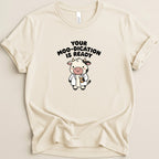 Cream t-shirt with cartoon cow wearing a lab coat, holding a pill bottle, text reads "Your Moo-dication Is Ready".