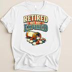 White t-shirt with "Retired But Not Expired" text and spilled pill bottle.