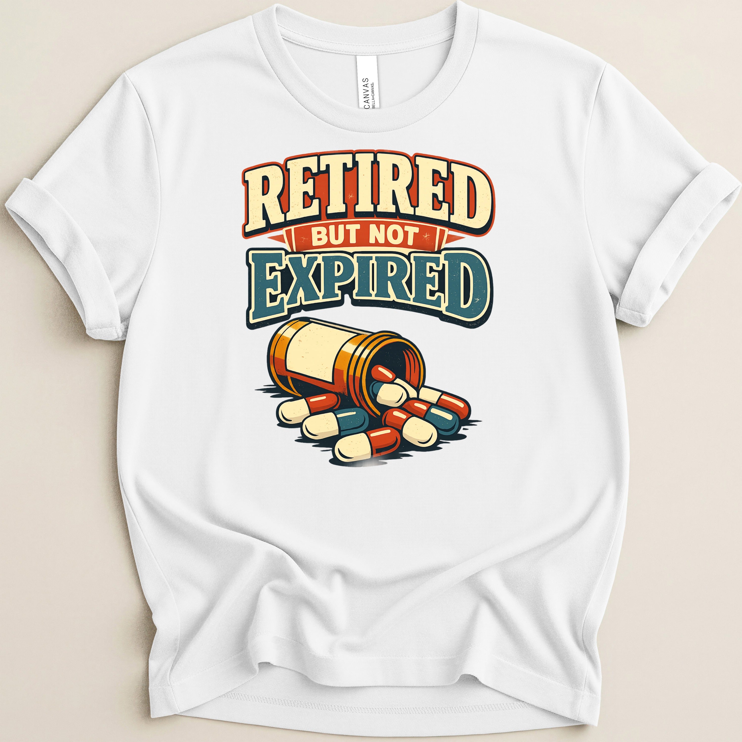 White t-shirt with "Retired But Not Expired" text and spilled pill bottle.
