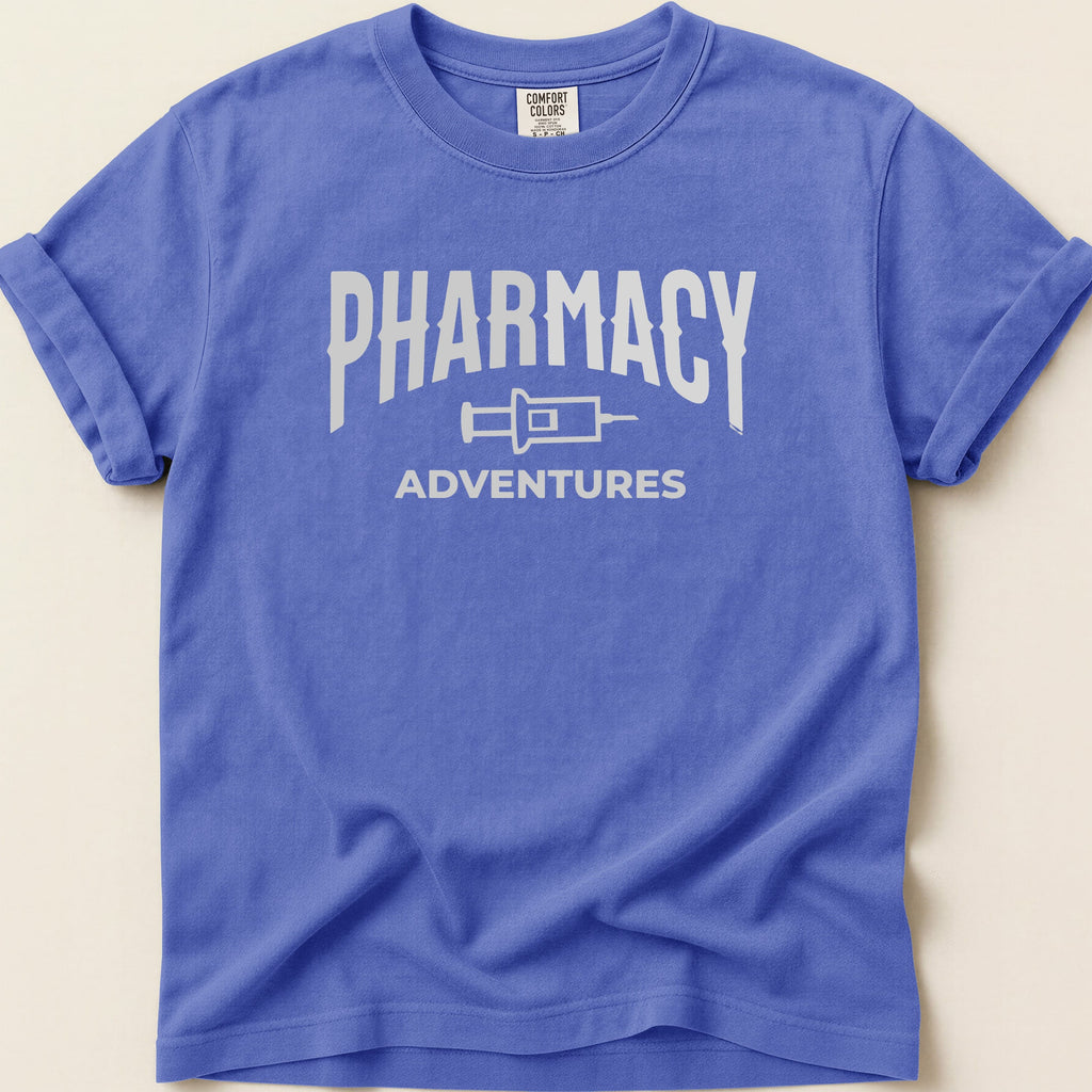 Blue t-shirt with "Pharmacy Adventures" text and syringe graphic.