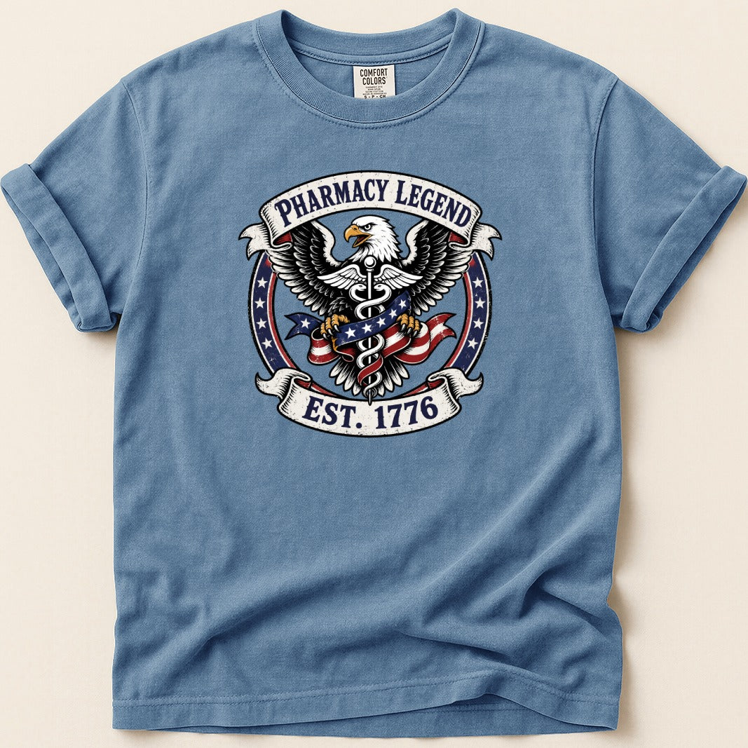 Eagle with American flag and "Pharmacy Legend Est. 1776" emblem on a blue t-shirt.