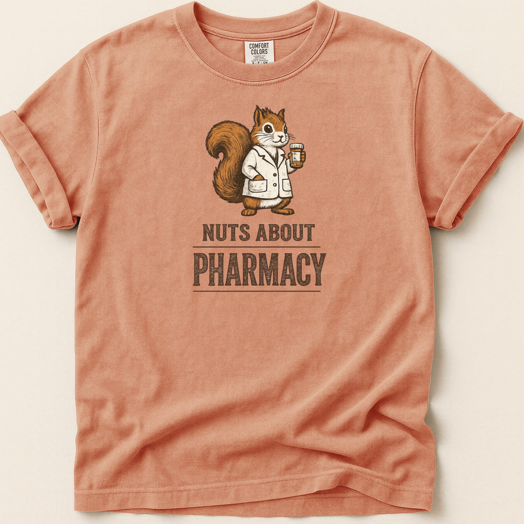 Orange shirt with a squirrel wearing a lab coat and holding medicine, text "NUTS ABOUT PHARMACY".