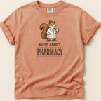 Orange shirt with a squirrel wearing a lab coat and holding medicine, text "NUTS ABOUT PHARMACY".