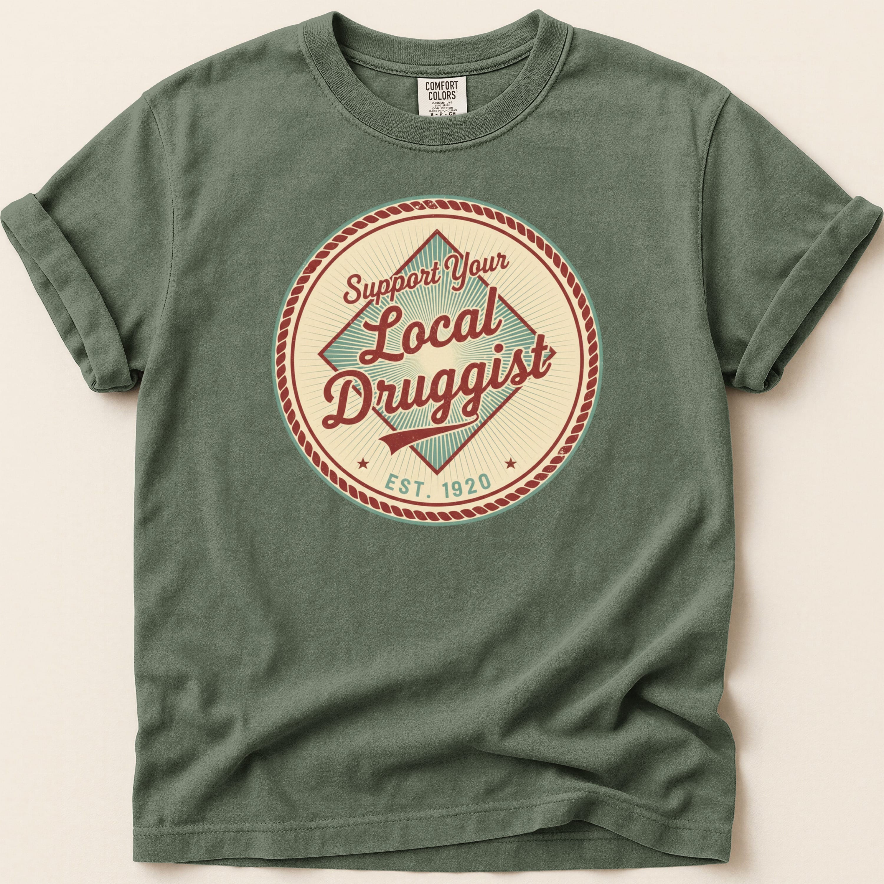 T-shirt with "Support Your Local Druggist EST. 1920" circular logo.
