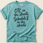 Teal t-shirt with black text reading "OTC on the streets, Schedule II in the sheets".