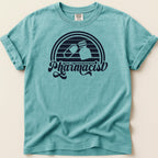 Teal t-shirt with "Pharmacist" text and pill capsule and bottle graphics.