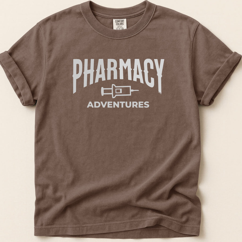 Brown t-shirt with white "Pharmacy Adventures" graphic.