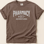 Brown t-shirt with white "Pharmacy Adventures" graphic.