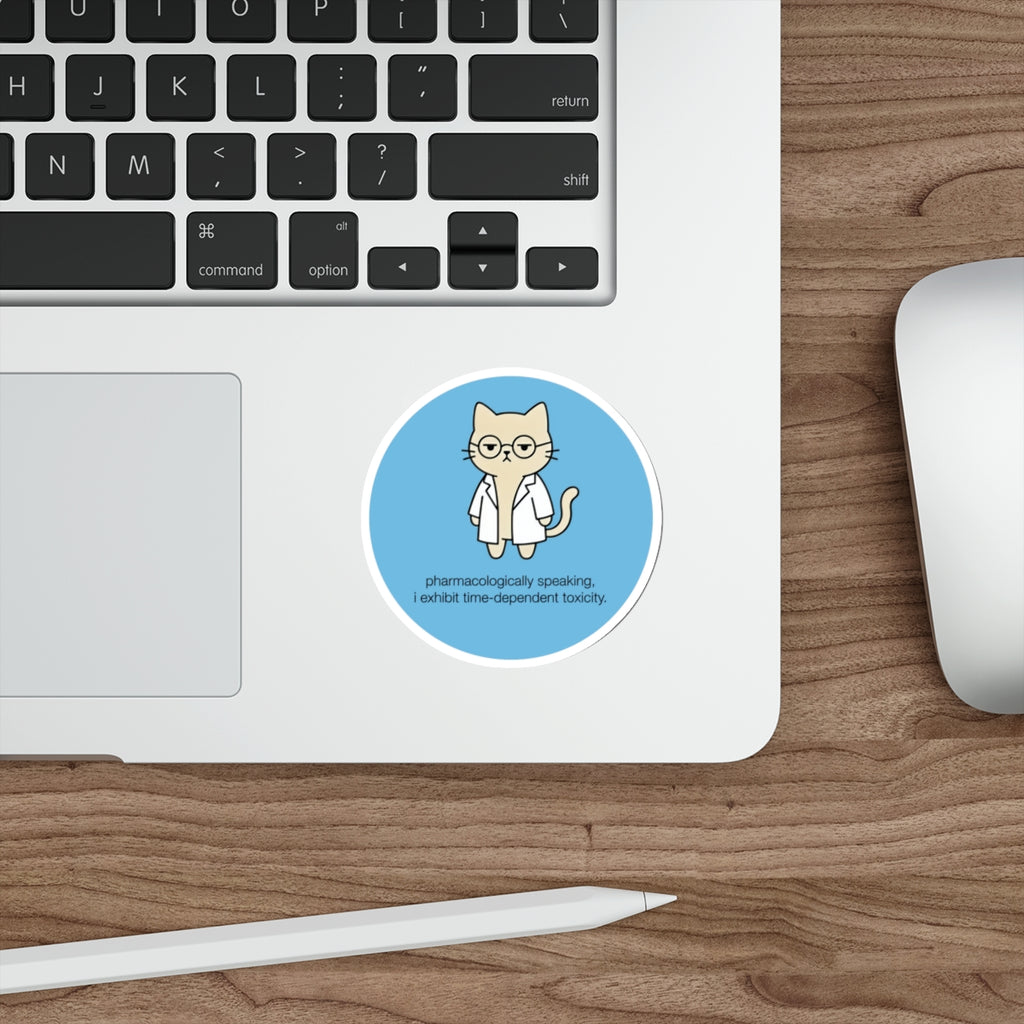 Circular sticker of a cat in a lab coat with text about toxicity.
