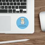 Circular sticker of a cat in a lab coat with text about toxicity.