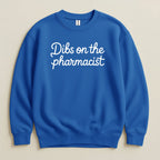 Blue crewneck sweatshirt with "Dibs on the pharmacist" text.