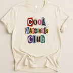 Cream t-shirt with colorful cutout letters spelling "Cool Pharmacists Club".