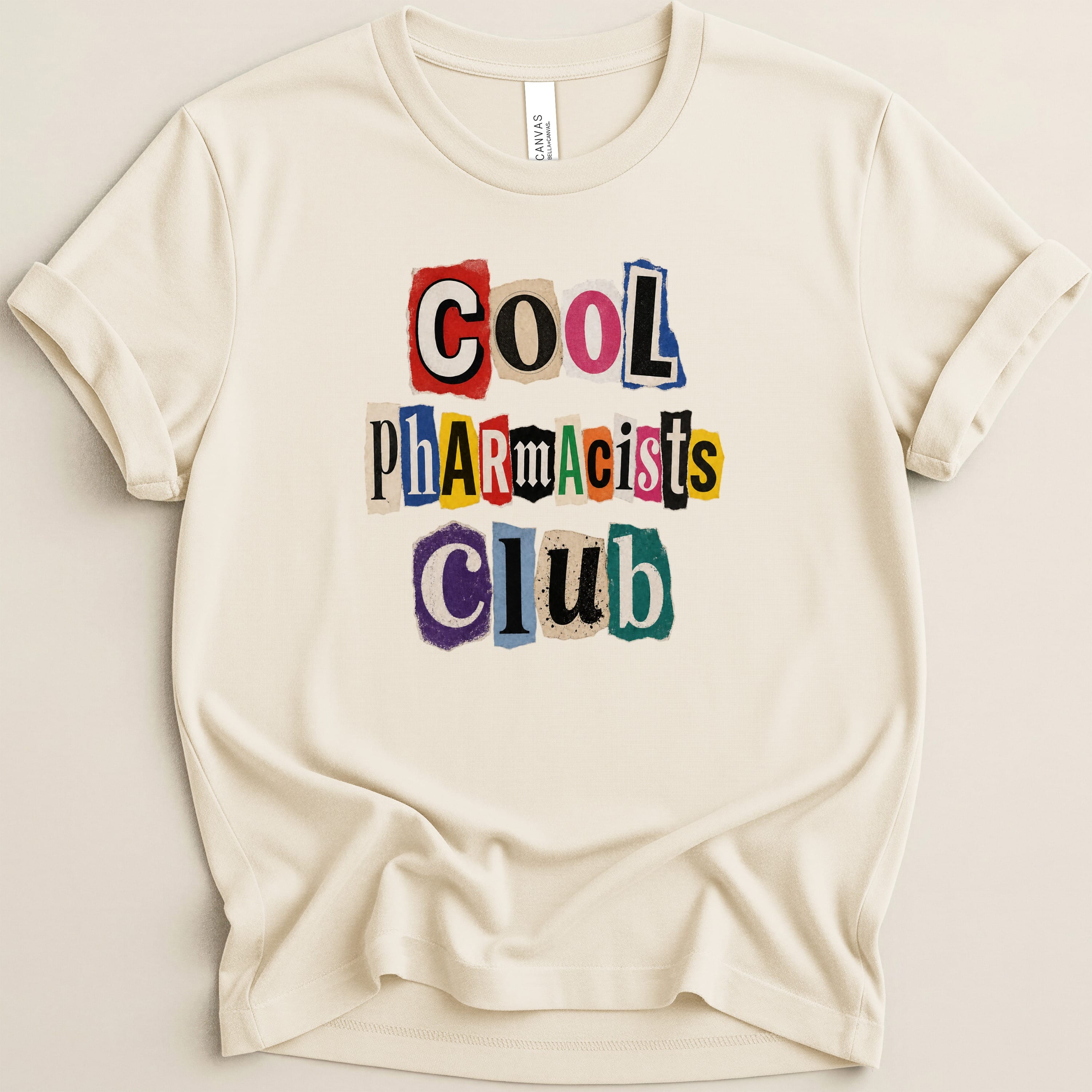 Cream t-shirt with colorful cutout letters spelling "Cool Pharmacists Club".