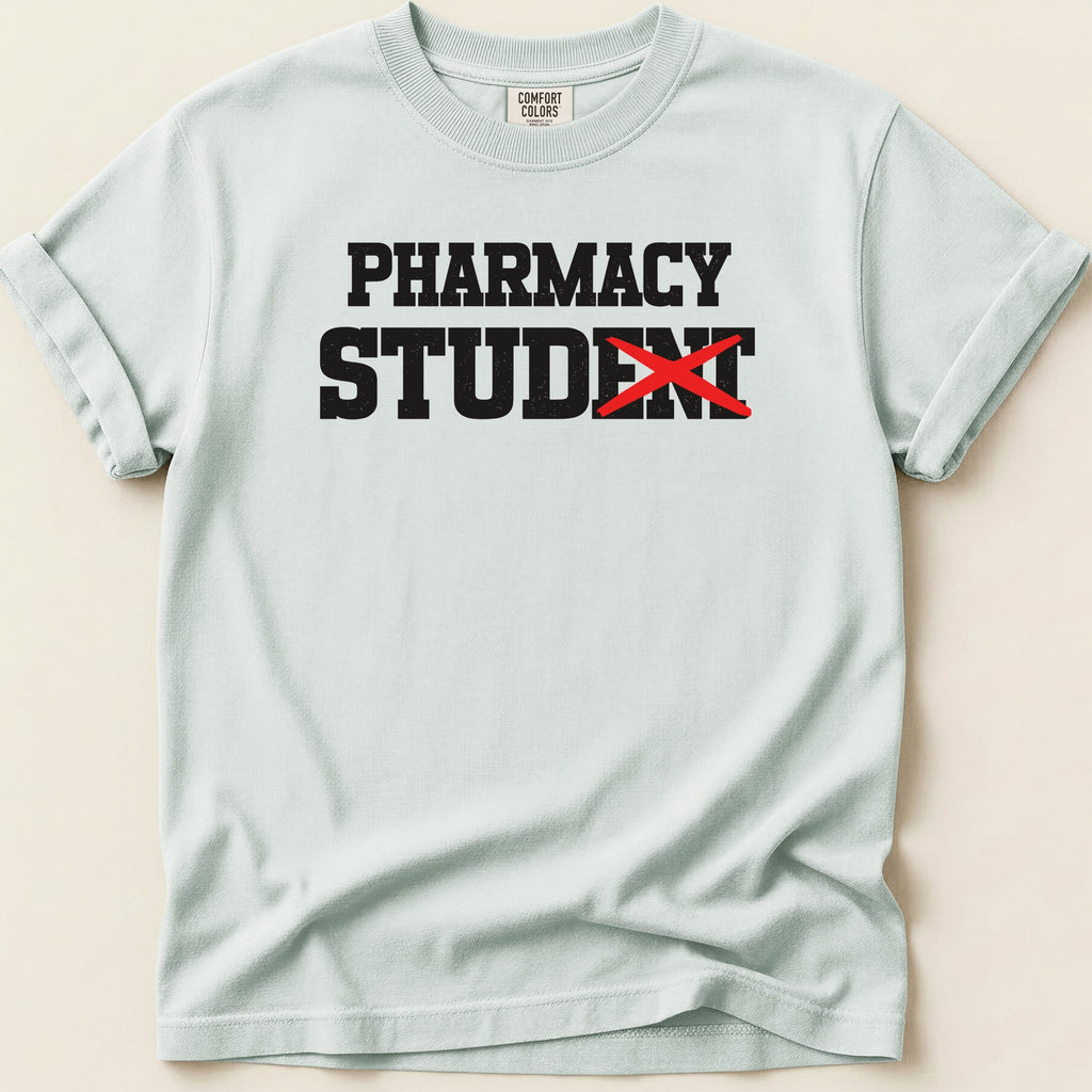 Light blue t-shirt with "PHARMACY STUDENT" text, the "ENT" crossed out.